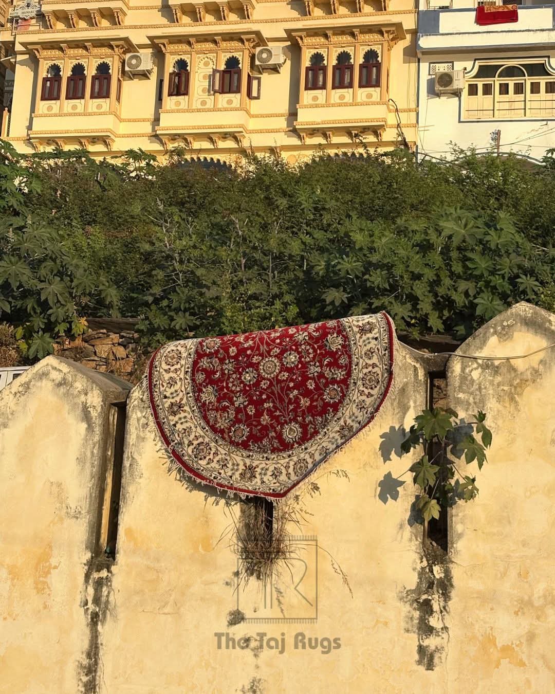 Round hand knotted red floral rug by The Taj Rugs